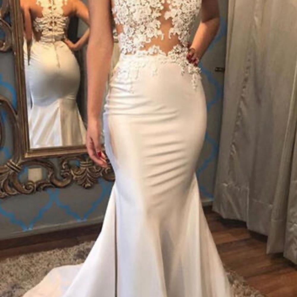 Wedding dress with skin tone bodice appliqué and a satin skirt and train.